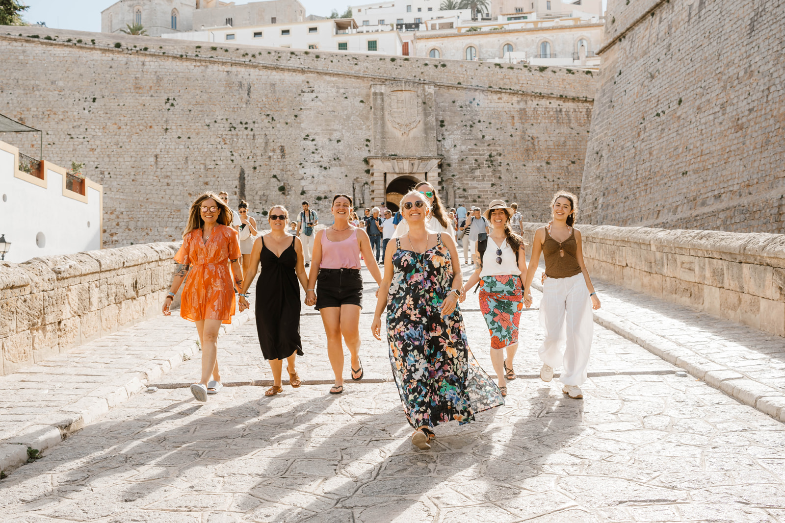A group of happy women walking in the sun